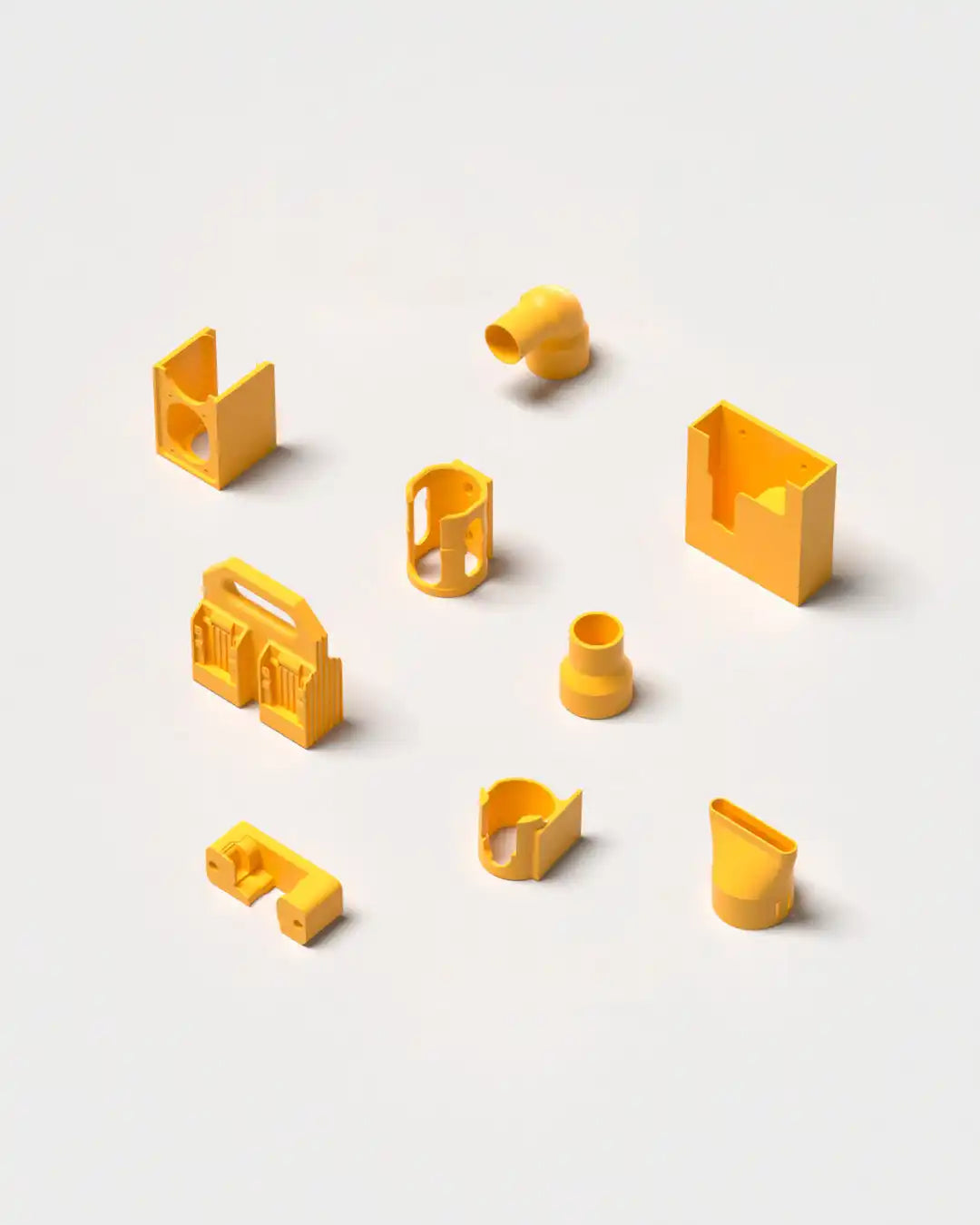A collection of yellow 3D-printed plastic parts.